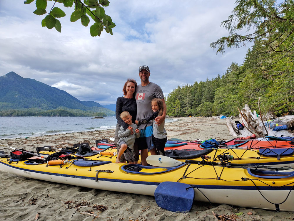 family on beach kayaking tour