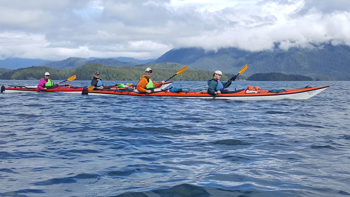 family kayaking tour on the water