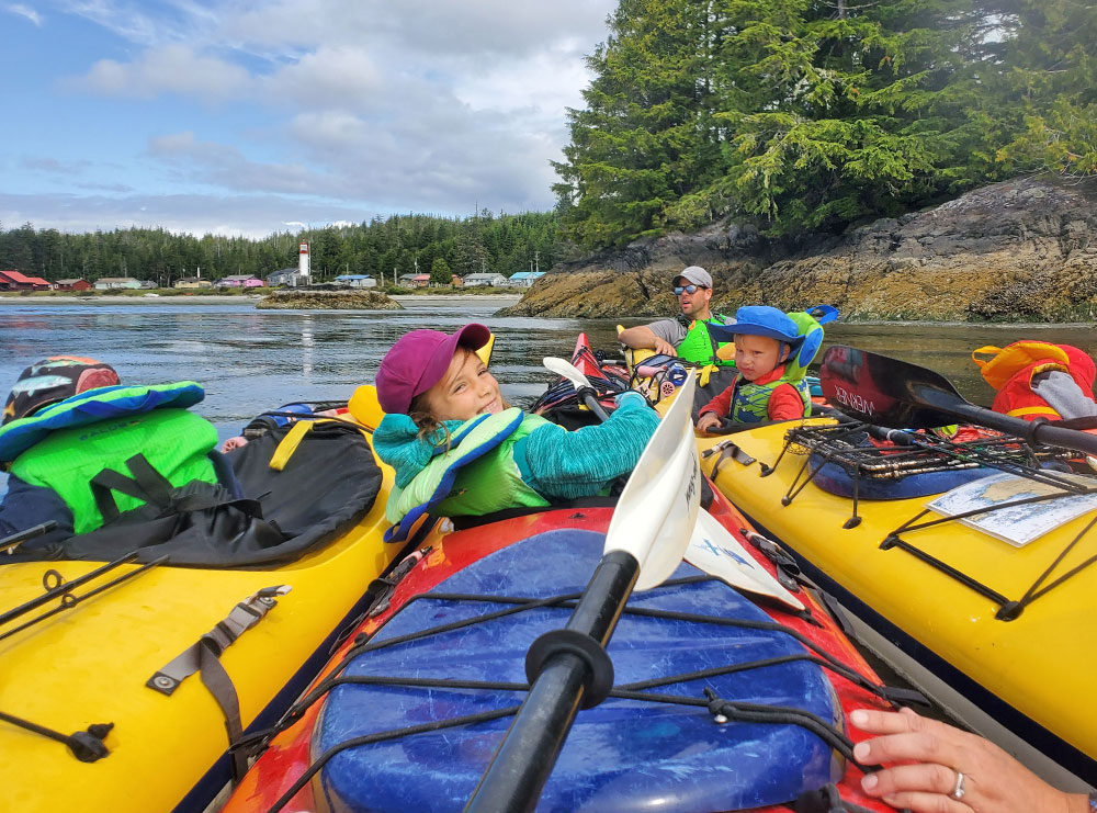 family kayaking with young kids